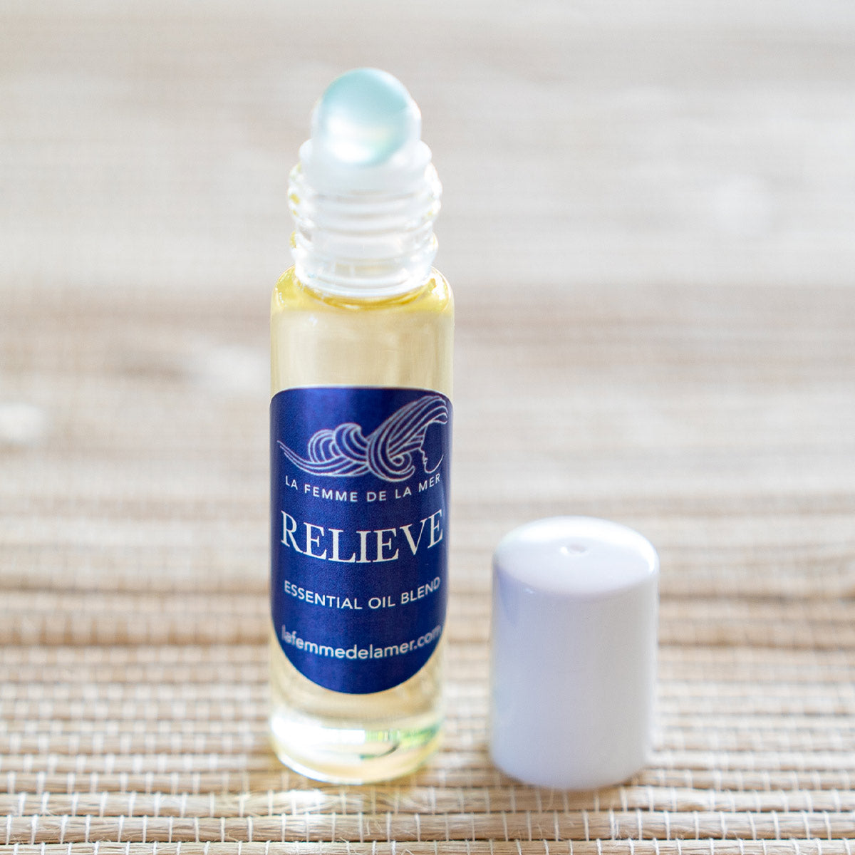 relieve essential oil roller small front 0.33 oz dark blue and white label