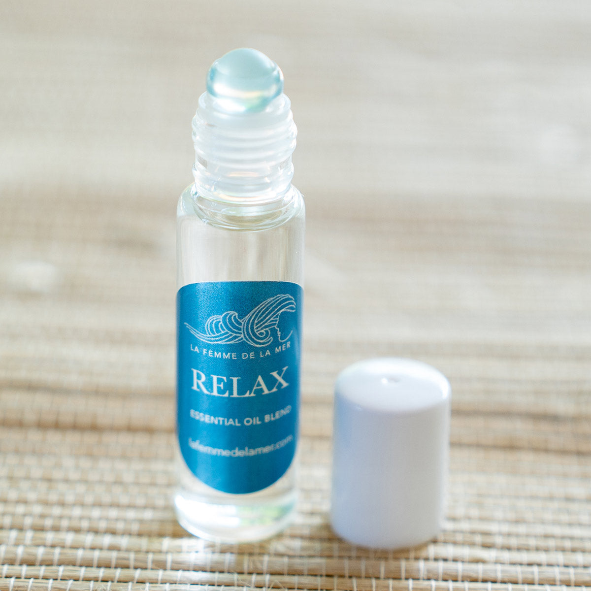 relax essential oil roller small front 0.33 oz blue and white label