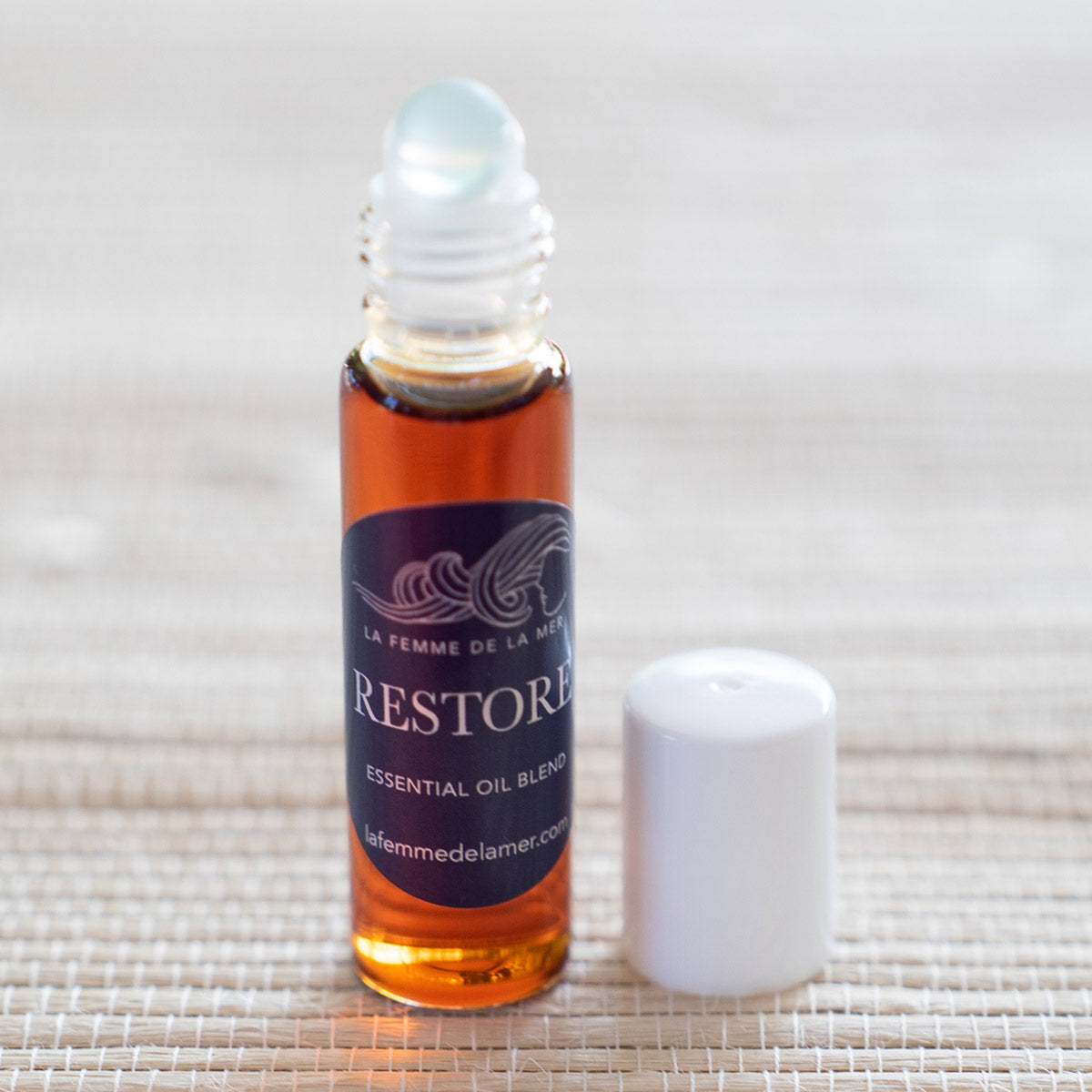 restore essential oil roller small front 0.33 oz purple and white label